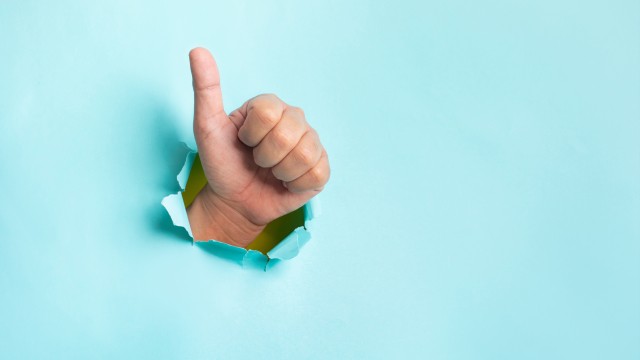 Effect result concepts with hand showing thumb up on blue background.copy space