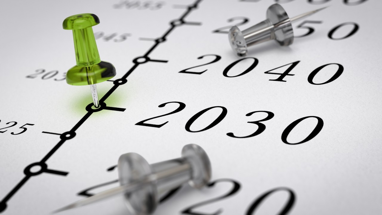 Year 2030 written on a paper with a green pushpin, concept image for business vision or long term prospective. Number two thousand thirty. 