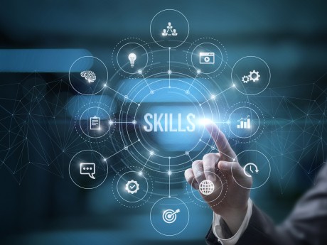 Businessman on virtual computer screen click on skills on blurred background.