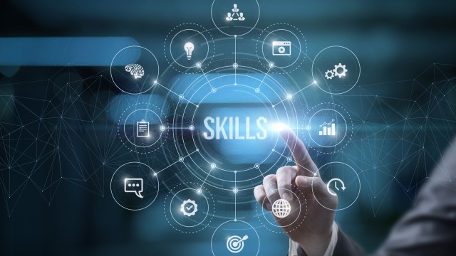 Businessman on virtual computer screen click on skills on blurred background.