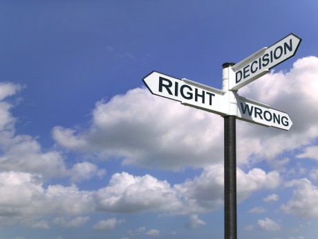 Concept image of a signpost with Decision Right or Wrong against a blue cloudy sky