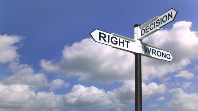 Concept image of a signpost with Decision Right or Wrong against a blue cloudy sky